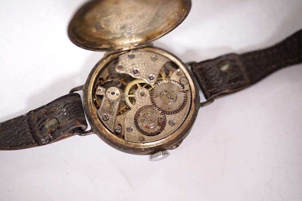 An early 20th century silver Borgel cased manual wind wrist watch(a.f.), one other similar silver half hunter manual wind wrist watch(no strap) and one other similar with a strap. Condition - poor